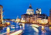 Evening view of Grand Canal traffic and Basilica di Santa Maria della Salute, Venice, Italy