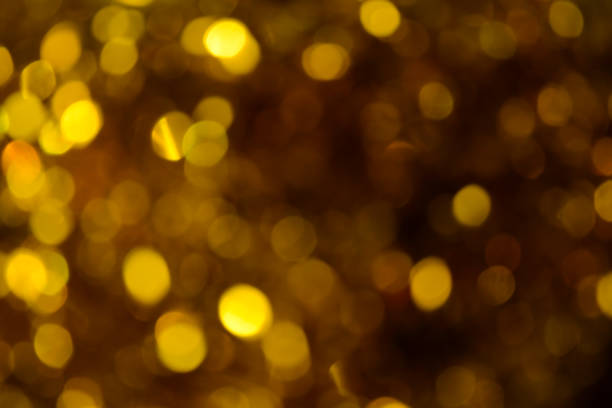 istock Bokeh. Holiday background. Christmas lights. Glitter. Defocused sparkles. New Year backdrop. Festive wallpaper. Blinks. Carnival. Tinsel. Bokeh retro style photo. Golden. Gold. 1182456005