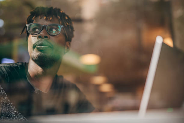 istock Man sitting in coffee shop and using laptop 1182457147