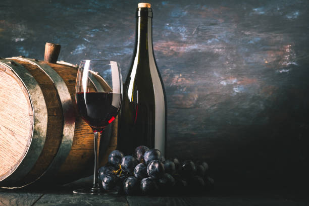 istock Red wine and wooden barrel 1182457375