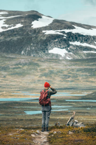 istock Man walking towards the mountains 1182461721