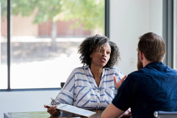 istock Caring therapist gives advice to young man 1182464306