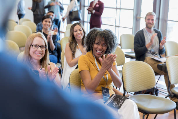 istock Crowd applauds keynote speaker during conference 1182464436
