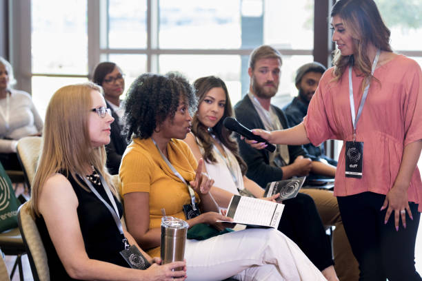 istock Confident mature woman asks question during seminar 1182464445