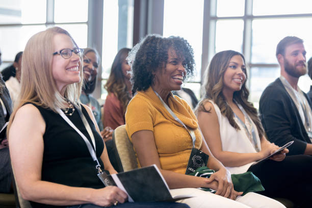 attentive people smile during conference - attending imagens e fotografias de stock