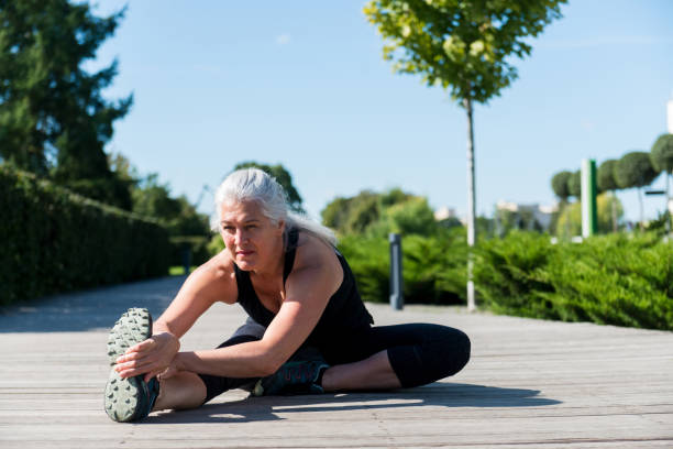 istock Serious mature woman stretches before workout 1182464563