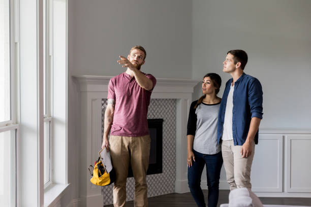 istock Handyman discusses home repairs with homeowners 1182464633