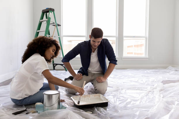 istock Happy expectant couple paint nursery 1182464647