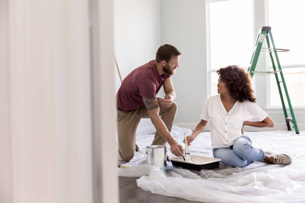 istock Couple talk while painting a room 1182464649