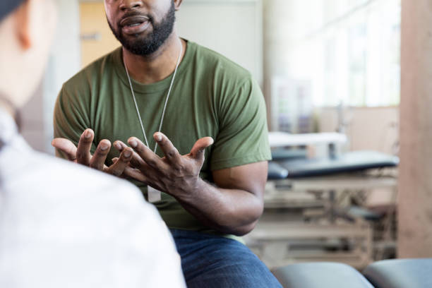 istock Unrecognizable male patient holds out hands while describing symptoms 1182464891