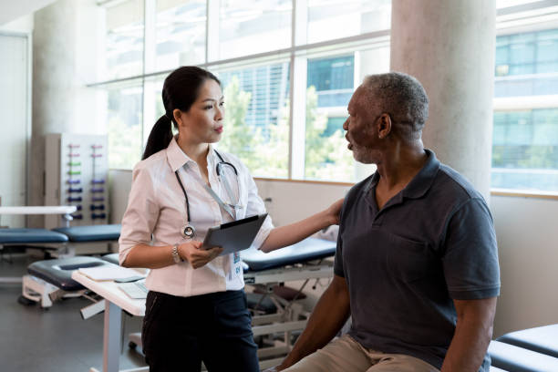 istock Orthopedic doctor talks with senior patient 1182464964