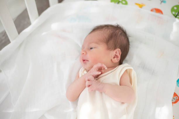 istock Newborn baby in the crib 1182465134