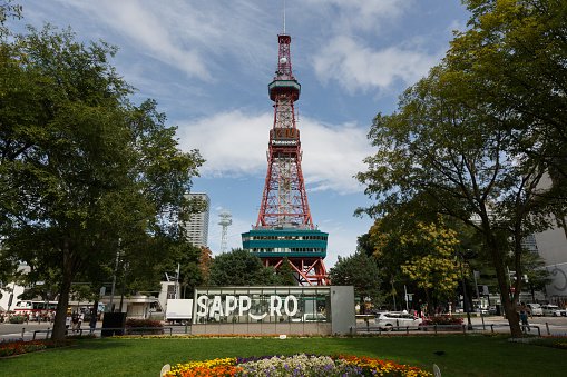 Sapporo, Japan - August 21, 2019 : Odori Park in Sapporo, Hokkaido, Japan. Throughout the year, many events are held in the Odori Park. The Sapporo TV Tower have an observation deck, souvenir shop and restaurant. It is a famous tourist attraction in Sapporo.