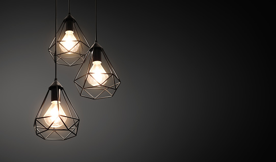 Decorative ceiling lights / hanging lights on dark background with copy space