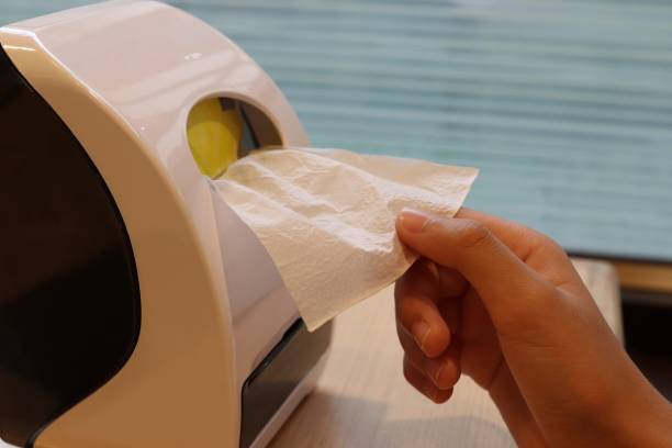 istock hand pulling tissue paper out of the box 1182466679