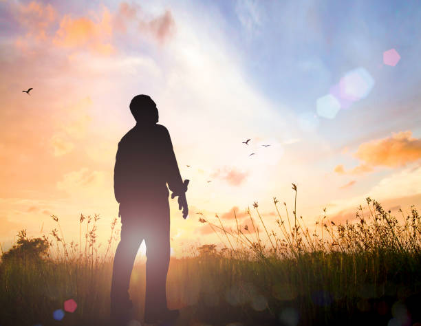 International human rights day concept Human standing over meadow sunset background easter sunday photos stock pictures, royalty-free photos & images