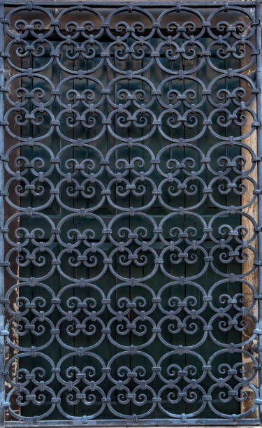 istock Forged antique openwork metal grid on the window 1182468212