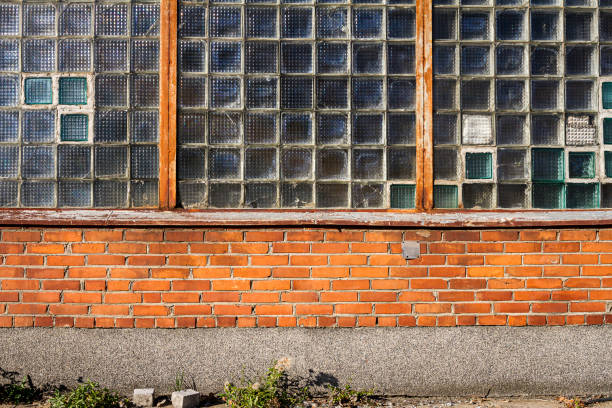 Red brick wall with glass block window. Architecture detail.