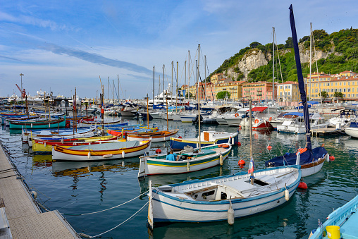 Small colourful fishing boats share the old port at Nice with luxurious super yachts.