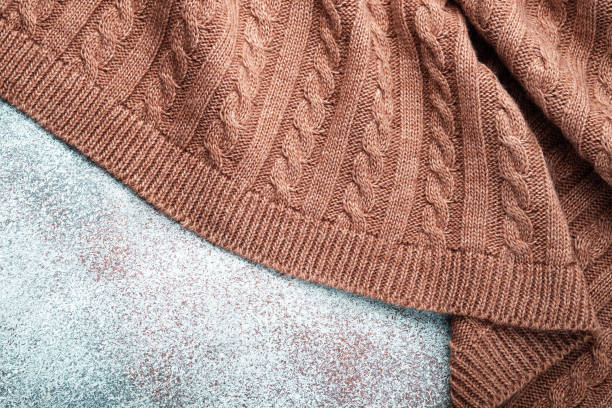 istock Folds of a knitted woolen blanket, top view 1182469598