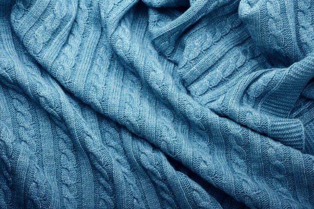 istock Folds of a knitted woolen blanket, top view 1182469628