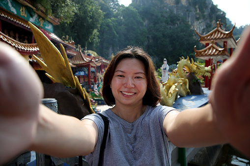 A female adult is enjoying sightseeing at serene view of Chinese temple in Ipoh, Perak Malaysia.