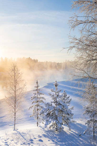 Photo of Mist over freezing river on a sunny cold winter day
