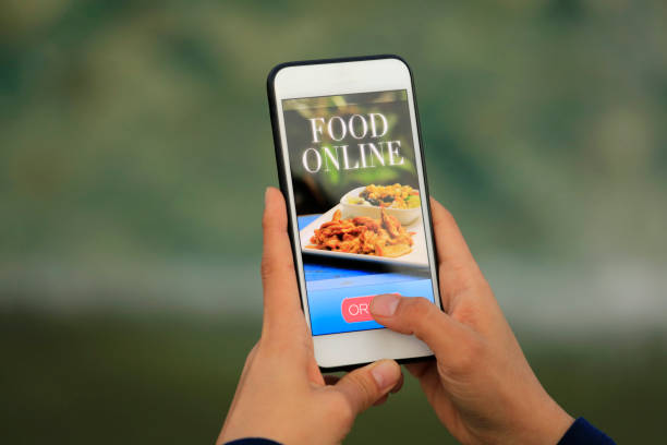 istock Woman using meal delivery service through mobile app 1182470995