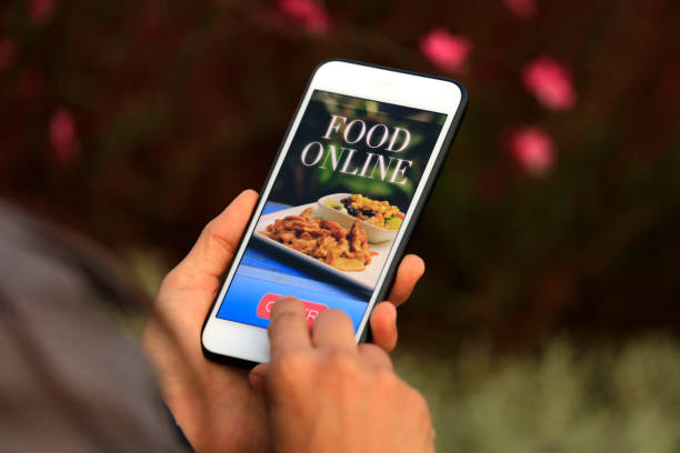 istock Woman using meal delivery service through mobile app 1182471054