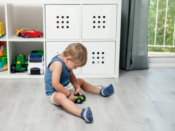 istock Litlle boy playing with a car 1182474389