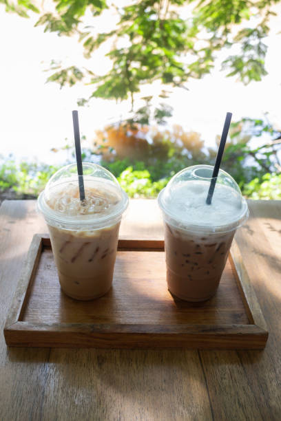 istock Iced coffee on wooden outdoors table 1182474435
