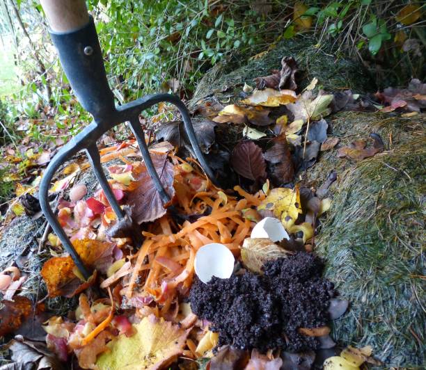 Heap of compost Compost pile at the bottom of the garden garden fork stock pictures, royalty-free photos & images