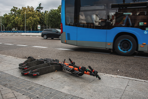 Electric push scooters on the floor, left in a bad conservation state