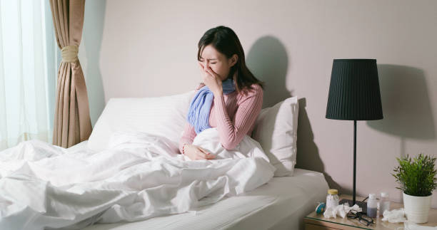 istock woman sick at home 1182476196