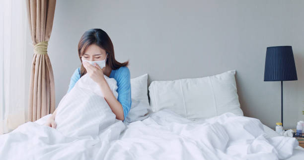 istock asian woman cough in bedroom 1182476241