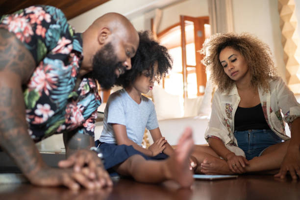 istock Happy family talking and using digital tablet 1182476462