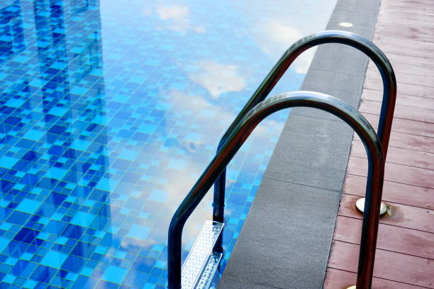 istock Grab bars ladder in the blue swimming pool 1182476550