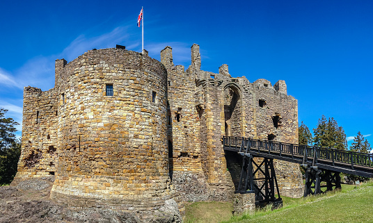 Dirleton Castle is a medieval fortress dating from the 13th century. It stands on a rocky outcrop at the heart of rich agricultural lands in the village of Dirleton, East Lothian, Scotland.