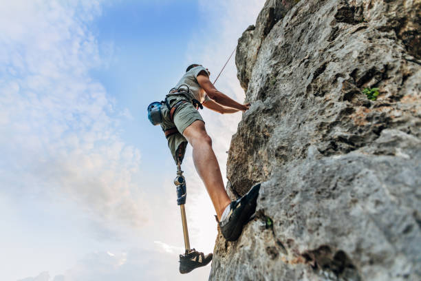 istock Disability man free rock climbing 1182477630