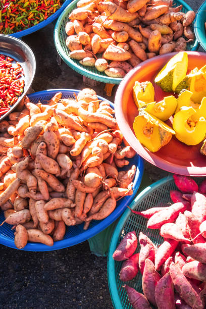 istock Fresh and multi-coloured tropical vegetables at local market. 1182477662