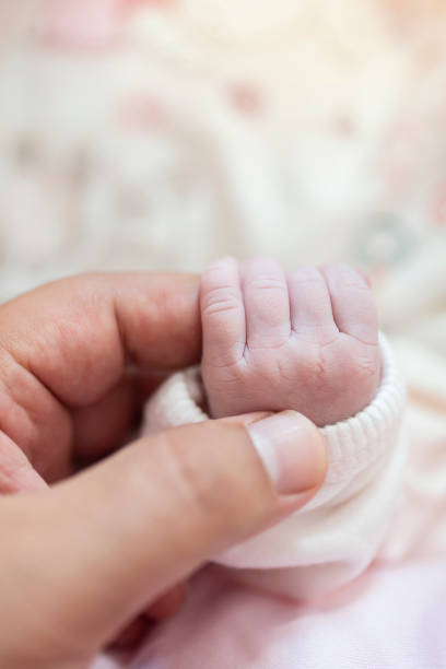 istock Baby Holding Mothers Hand 1182477733