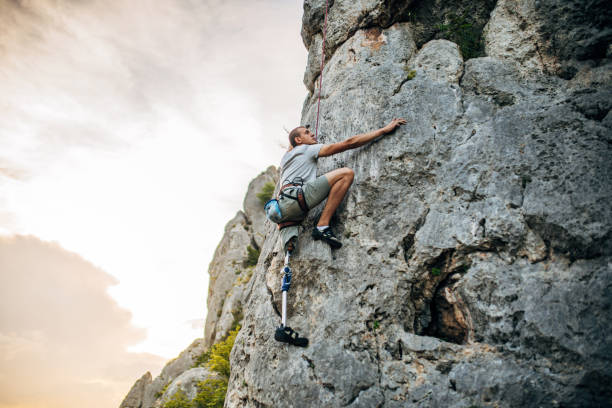 istock Disability young man free  climbing 1182477864