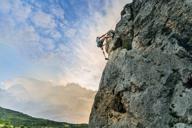 istock Disability young man free rock climbing 1182478217