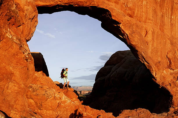 istock Hiker Going Down Rocks In Arches National Park, Utah 118247872