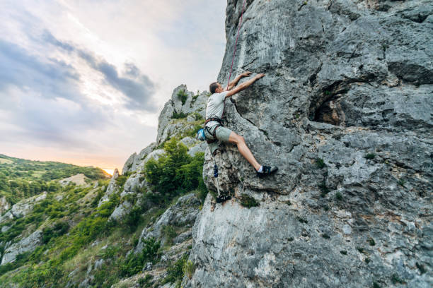 istock Disability young man free rock climbing 1182478854
