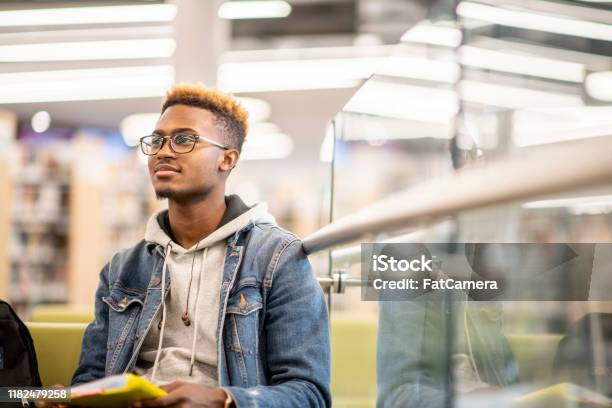 An African American University Student Studying In The Library Stock Photo Stock Photo - Download Image Now