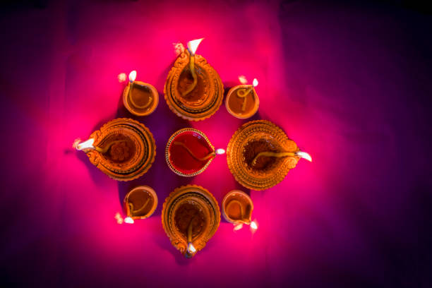 istock Colorful clay diya lamps lit during diwali celebration 1182479452