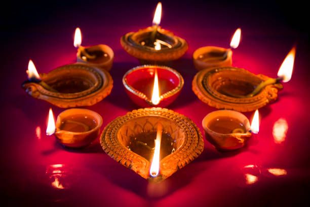 istock Colorful clay diya lamps lit during diwali celebration 1182479466
