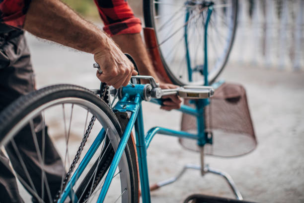 istock Man repairing bicycle in front yard 1182480576