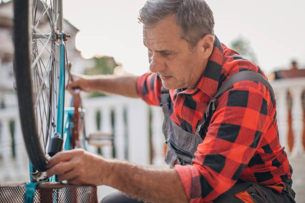 istock Senior man repairing bicycle 1182480830